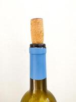 Closeup of a wine bottle with cork. Simple, elegant, use for concepts like celebration, relaxation, or winemaking. Suitable for food, beverage, and lifestyle related content. photo
