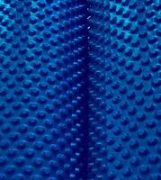 Same Size Round 3D Elements On Blue Rolls. Textured Stock Image With Blue Extruded Cells Abstract Pattern photo