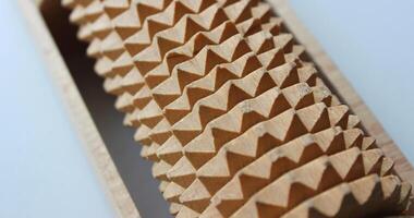 Accuracy spikes on a wooden cylindrical detail on white background close up stock photo