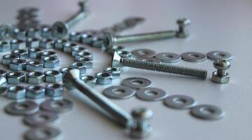 Shiny Metalware Items Laid Out In Decorative Pattern On White Table Macro Shot Stock Photo