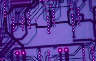 Abstract Electronic Board With Violet Neon Backlight Texture Background photo