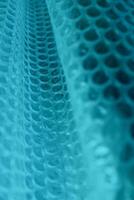 Abstract Background With Blue Cells On Folded Mesh Structure. Pattern Of Abstract Blue Elements In A Rows photo