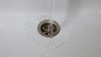 a stream of water flows from the tap into the sink video