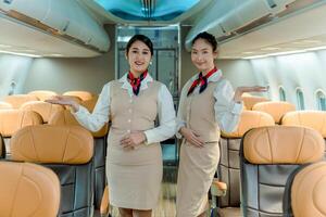 Professional flight attendants welcoming passengers onboard, standing in airplane aisle with friendly smiles, offering exceptional service and hospitality photo