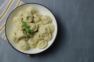 dumplings on a plate on a gray background with space for text copyspace top view upper angle. National food photo
