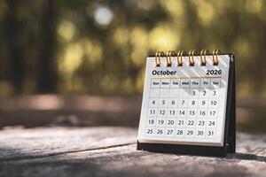 Calendar page October of the year 2026 on a natural background, with copy space and business design. Concept of monthly planning, important schedules, meetings, and appointments. photo
