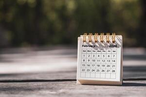 Calendar page February of the year 2026 on a natural background, with copy space and business design. Concept of monthly planning, important schedules, meetings, and appointments. photo