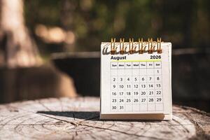 Calendar page August of the year 2026 on a natural background, with copy space and business design. Concept of monthly planning, important schedules, meetings, and appointments. photo