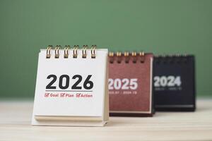 Calendar page of 2026, white on wooden table. Concepts of planning for success, setting goals, planning strategies, and taking action steps. photo