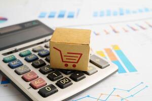 Online shopping, Shopping cart box on calculator, import export, finance comm photo