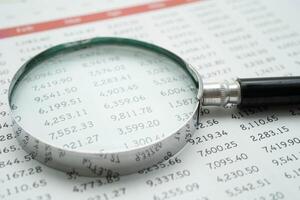 Magnifying glass on charts graphs paper. Financial development, Banking Account, Statistics, Investment Analytic r photo