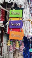 A display of colorful bells hanging from a string photo