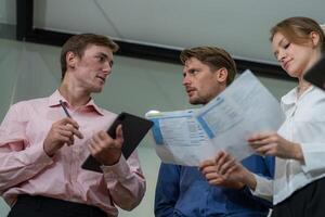 Team members collaborate on project proposals during a brainstorming session in a modern office setting photo