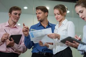 Professionals collaborating during a meeting in a modern office setting discussing business strategies and sharing ideas photo