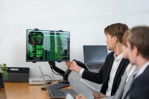 Professionals analyzing data on computer screen in modern office setting during business meeting photo