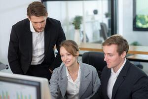 Business team collaborating on a project in a modern office setting during the day photo
