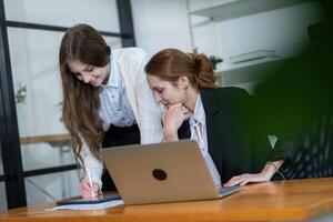 Colleagues collaborating in a modern office space during a team meeting discussing project plans and ideas photo
