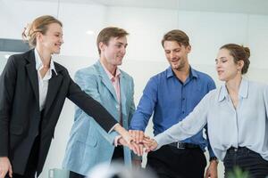 Group of professionals collaborating in a meeting room while expressing teamwork and unity in a corporate environment photo