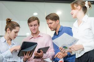 Team collaborating on project in modern office setting during daytime photo