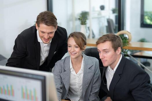 Team collaboration in a modern office with three professionals discussing project details and analyzing data on a computer screen photo