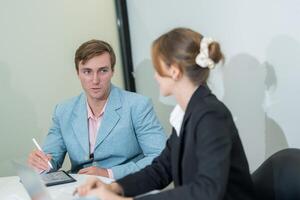 Professional meeting between colleagues discussing project details in a modern office environment photo