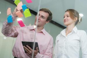 Collaborative brainstorming session in a modern office with colorful sticky notes photo