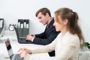 Focused professionals collaborating in a modern office space during a productive workday photo