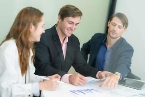 Professionals collaborate in a modern office environment during a business meeting focused on project planning and strategy development photo