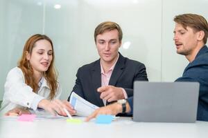 Professionals discussing project ideas in a modern office during a collaborative meeting photo