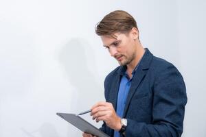 Office worker conducts digital note-taking on a tablet during a meeting session in a corporate environment photo