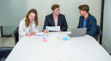 Team collaborating in a modern office setting during a business meeting in the afternoon photo