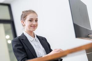 Young professional woman working at a modern desk in a contemporary office setting during the day photo