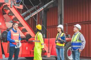 Group of engineer and foreman worker team in industry containers yard, Workers collaborating at shipping container cargo photo