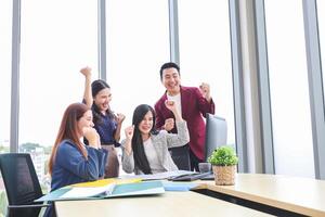 Cheerful Business Team Celebrating Success in Modern Office, Team Meeting and Brainstorming Concepts photo