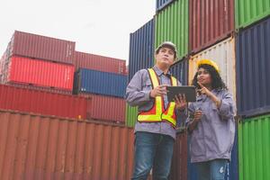 Engineer and Foreman Dock Worker Inspecting Containers Box at Cargo, Logistics Team at Shipping Yard photo