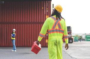 Engineer and foreman dock worker inspecting containers box at cargo, Diverse team of workers collaborating at shipping container cargo photo