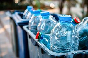 Blue trash can with several bottles of water in it photo