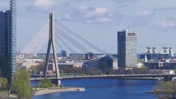 View of Riga, Latvia, featuring the Daugava River, Riga TV Tower, and Vansu Bridge. The shows a sunny day with a slow pan or zoom motion. video