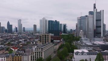 Aerial view of Frankfurt, Germany, showcasing the skyline with Commerzbank Tower, the Main River, green parks, and historic architecture in motion. video