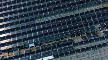 Photovoltaic panels on building roof. Unbuilt solar farm on top of a house. Renewable source of energy. Construction of a modern solar farm. Aerial view. video