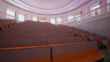 Lecture hall with nobody. Modern educational auditorium in the university. Interior of a large empty classroom during coronavirus pandemic. video