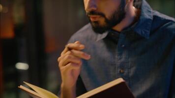 Thoughtful Indian business man journalist write notebook Arabian male guy businessman think idea project at office night late working studying ponder create plan happy answer solution writing notes video