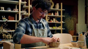 Professional sculptor potter man Caucasian guy teacher artist craftsman modeling clay online master class in pottery workshop create handcraft teaching handmade by laptop art work guidance call video