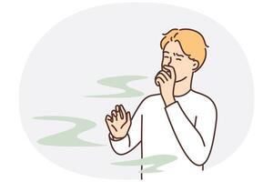 Man covers nose so as not to smell unpleasant smell from harmful production vector