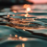 Rippling water reflects sunlight at evening twilight photo