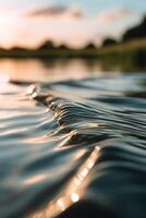 Rippling water at sunset near a tranquil landscape photo
