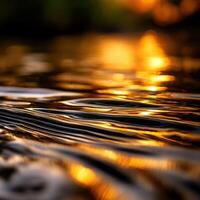 A close up of water with a sunset in the background photo