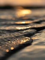 Water surface reflecting golden light at sunset photo