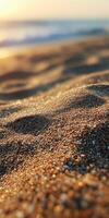 A beach with sand and water at sunset photo