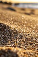 Glimmering sand at sunset along a serene beach photo